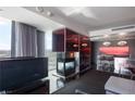 Modern living room with stylish fireplace, city views, and open floor plan at 4381 W Flamingo Rd # 2122, Las Vegas, NV 89103