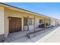 Inviting front porch with brick accents, a covered entryway, and a glimpse of the attached garage at 4409 W Red Coach Ave, North Las Vegas, NV 89031