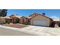 Street view of the home's exterior with tan stucco, tile roof, and low maintenance landscaping at 4619 Reliant St, North Las Vegas, NV 89031