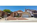 Cozy home featuring a tile roof, manicured landscape, and convenient two-car garage at 4619 Reliant St, North Las Vegas, NV 89031