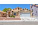 Inviting single-story house featuring a two-car garage and low-maintenance desert landscaping at 4619 Reliant St, North Las Vegas, NV 89031