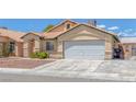 Cozy single-story home with a two-car garage, desert landscaping, and charming curb appeal at 4619 Reliant St, North Las Vegas, NV 89031