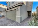 Stylish two-story home featuring a two-car garage, paved walkway, and a welcoming entrance at 4977 Birchland Manor Ave, Las Vegas, NV 89139