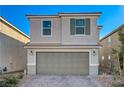 Inviting two-story home showcasing a spacious two-car garage, neutral stucco exterior, and well-maintained landscaping at 4977 Birchland Manor Ave, Las Vegas, NV 89139