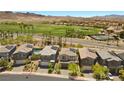 Aerial view of homes showcasing solar panels, swimming pool, and proximity to a golf course at 55 Strada Fontana, Henderson, NV 89011
