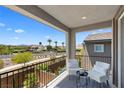 Relaxing balcony featuring outdoor seating with a scenic view of the neighborhood and palm trees at 55 Strada Fontana, Henderson, NV 89011