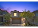 Charming two-story home featuring a well-maintained front yard with green landscaping at 55 Strada Fontana, Henderson, NV 89011