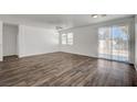 Bright and airy living room with modern flooring, ceiling fan, and access to the backyard at 5622 Sage Pines Dr, Las Vegas, NV 89118