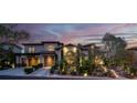 Elegant home with two-car garage, manicured landscaping, and a beautiful tile roof at dusk at 628 Chervil Valley Dr, Las Vegas, NV 89138