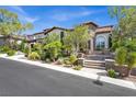 Beautifully landscaped home with stone steps leading to the front entrance at 628 Chervil Valley Dr, Las Vegas, NV 89138