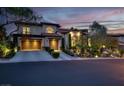Elegant home with two-car garage, manicured landscaping, and a beautiful tile roof at night at 628 Chervil Valley Dr, Las Vegas, NV 89138