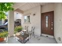 Inviting front porch with outdoor seating, plants, and a stylish front door at 6729 Churnet Valley Ave, Las Vegas, NV 89139