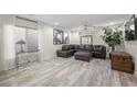 Spacious living room featuring hardwood floors, large windows, and modern decor at 6729 Churnet Valley Ave, Las Vegas, NV 89139