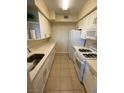 Well-equipped kitchen featuring appliances, ample counter space, and white cabinets at 7159 S Durango Dr # 206, Las Vegas, NV 89113