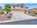 Charming two-story home with a balcony, tile roof and driveway leading to the two-car garage at 7310 Heggie Ave, Las Vegas, NV 89131