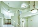 Bright staircase with white railings and unique architectural design, complemented by modern lighting fixtures at 7429 Fencerow St, Las Vegas, NV 89131