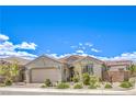 Inviting single-story home featuring a well-maintained front yard, mature desert landscaping, and an attached two-car garage at 8269 Skye Peak St, Las Vegas, NV 89166