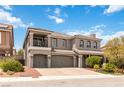 Elegant two-story home featuring a three-car garage and landscaped front yard at 8275 Old Creek Ranch St, Las Vegas, NV 89139