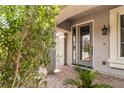 Inviting front entrance with manicured landscaping and a decorative glass door at 8275 Old Creek Ranch St, Las Vegas, NV 89139
