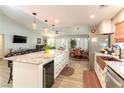 Spacious kitchen island with bar seating, wine cooler, and views of the living and dining areas at 8516 Millsboro Dr, Las Vegas, NV 89134