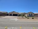 Charming single-story home featuring a three-car garage and low-maintenance desert landscaping at 8665 Jerlyn St, Las Vegas, NV 89113