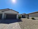 Charming single-story home featuring a three-car garage and low-maintenance desert landscaping at 8665 Jerlyn St, Las Vegas, NV 89113