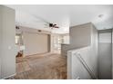 Open living area with neutral paint, a ceiling fan, and access to a balcony at 9050 W Warm Springs Rd # 2051, Las Vegas, NV 89148