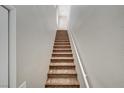 Carpeted staircase with a white handrail, offering a clean and simple design at 9050 W Warm Springs Rd # 2051, Las Vegas, NV 89148