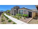 Charming home exterior with manicured landscaping, a walkway, and modern architectural details at 924 Allister Fields Ln, Las Vegas, NV 89138