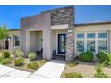 Beautiful home featuring a stone-accented entrance, modern design, and well-maintained landscaping at 924 Allister Fields Ln, Las Vegas, NV 89138