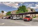 A view of the covered parking area and residential condo building in the background at 9303 Gilcrease Ave # 2198, Las Vegas, NV 89149