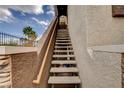 Exterior staircase leading to the upper-level units, set against a backdrop of palm trees at 9303 Gilcrease Ave # 2198, Las Vegas, NV 89149