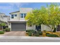 Inviting two-story home with desert landscaping, a stone accent wall, and a spacious garage at 9710 Hiking Ave, Las Vegas, NV 89166