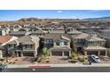 Beautiful aerial view of the home and the neighborhood with mountain views at 10057 Matter Overlook Dr, Las Vegas, NV 89178