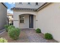 Inviting front entrance with decorative shrubs and a pathway leading to the front door at 10057 Matter Overlook Dr, Las Vegas, NV 89178