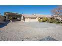 Desert home with a well-maintained lawn, ample parking space, and convenient carport at 10140 W Tropical Pkwy, Las Vegas, NV 89149