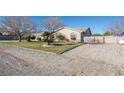 Charming desert home featuring a well-maintained yard and ample parking space at 10140 W Tropical Pkwy, Las Vegas, NV 89149
