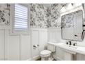 Charming powder room with floral wallpaper, white wainscoting, and modern fixtures at 10164 Phelps Lake Ct, Las Vegas, NV 89148