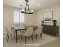Dining room featuring modern chandelier, sleek furniture, and neutral decor at 10164 Phelps Lake Ct, Las Vegas, NV 89148