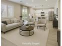 Bright living room with modern furnishings, neutral tones and large windows offering ample natural light at 10164 Phelps Lake Ct, Las Vegas, NV 89148