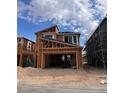 New two-story home under construction featuring a spacious garage and modern architectural design with blue sky at 10315 Water Knot Ave, Las Vegas, NV 89166