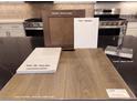 Interior design selection board featuring Simply White quartz, Layton Lake luxury vinyl plank, and Gibson Chrome faucet at 10315 Water Knot Ave, Las Vegas, NV 89166