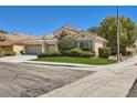 Charming single-story home with mature landscaping, a well-manicured lawn and a three-car garage at 1314 Rossini St, Henderson, NV 89052