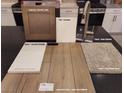 Display of kitchen finish samples with cabinets, paint, quartz, flooring and carpet at 1544 Little Penguin St, Las Vegas, NV 89138