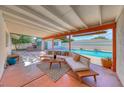 Spacious covered patio featuring an outdoor lounge area, fireplace, and stunning pool view at 1721 E Oakey Blvd, Las Vegas, NV 89104
