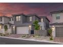 Modern home exterior featuring a two-car garage, stylish landscaping, and contemporary design at 2246 Bird Of Prey St, Las Vegas, NV 89138
