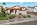 Charming single-story home with a desert rock landscape and a two-car garage at 2455 Silver Blossom Ln, Henderson, NV 89052