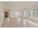Open-concept living room with tile flooring and lots of natural light at 2455 Silver Blossom Ln, Henderson, NV 89052