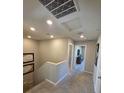 Upstairs hallway featuring neutral carpet and paint with recessed lighting, leading to other rooms at 2497 Rofrano Pl, Henderson, NV 89044