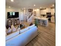 Open concept floor plan boasting a spacious living room and a modern kitchen with an island at 2497 Rofrano Pl, Henderson, NV 89044